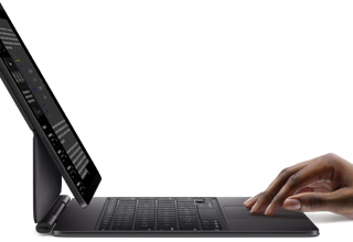 iPad Pro paired with iPad Magic Keyboard, hand using touchpad